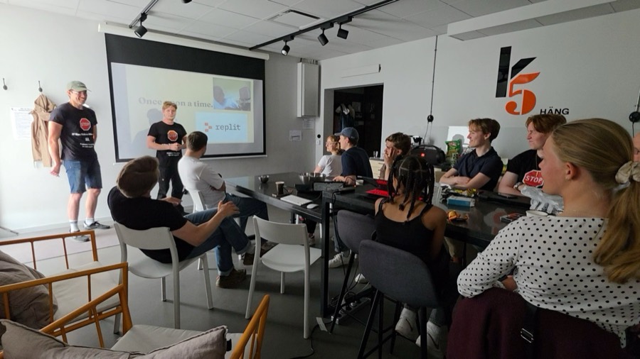 Workshop room with presenters and young participants around a long table